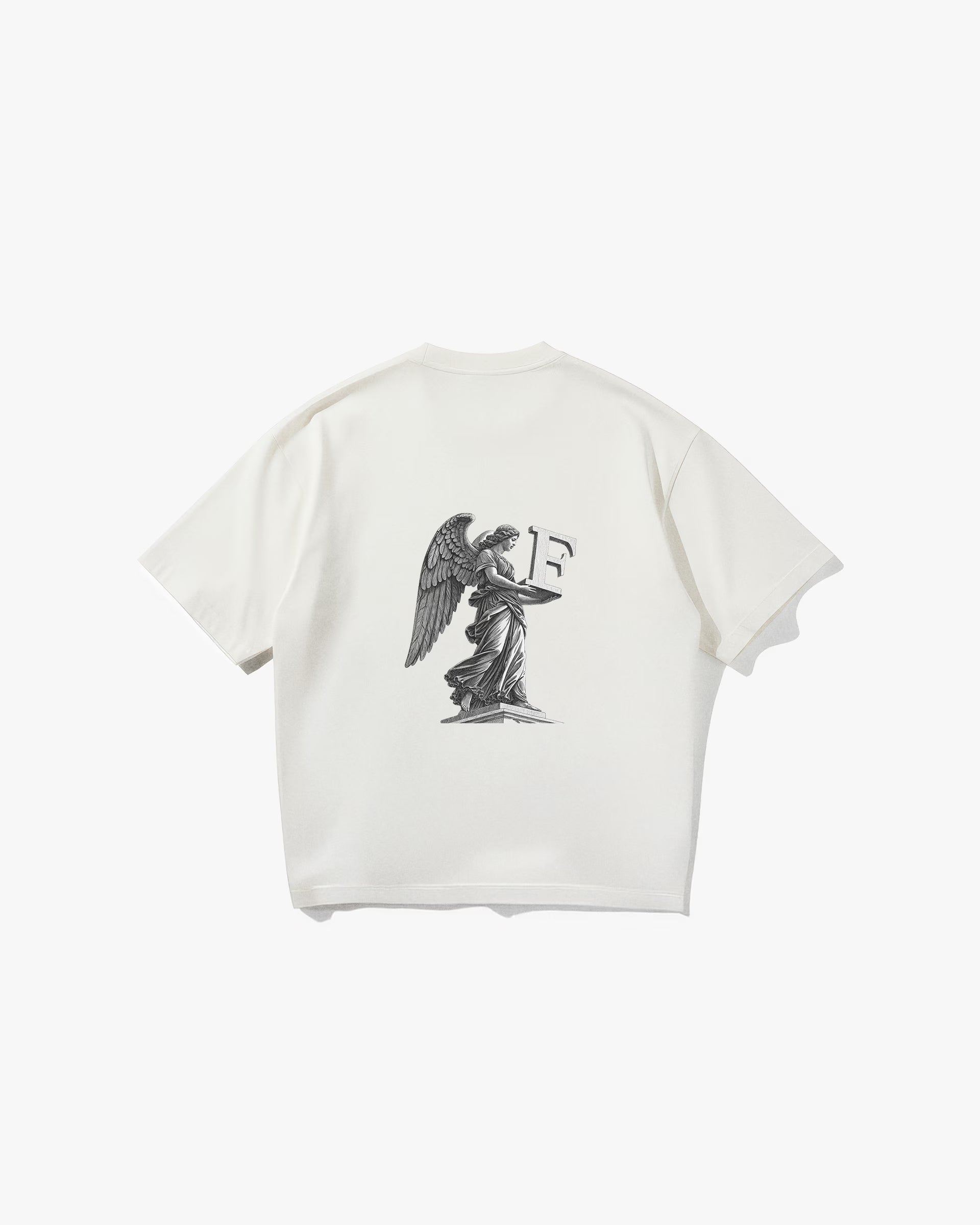 Angel Off White Oversize Tişört- Krem rengi (Off White) oversize tişörtün sırt yüzeyinin düz çekim ürün fotoğrafı. Tişörtün sırtında, siyah-beyaz tonlarda, büyük ve detaylı bir baskı bulunmaktadır. Baskı, bir kaide üzerinde duran kanatlı bir melek heykelini ve bu heykelin kollarında tuttuğu büyük, 3 boyutlu bir 'F' harfini tasvir ediyor